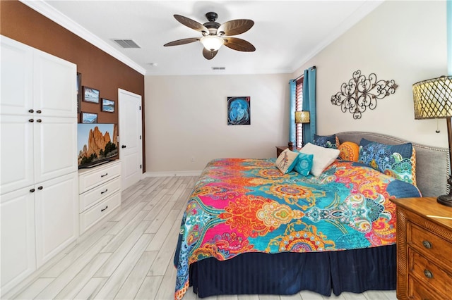 bedroom featuring crown molding, visible vents, and wood finish floors