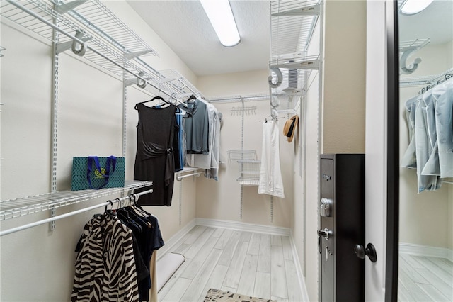 walk in closet featuring wood tiled floor