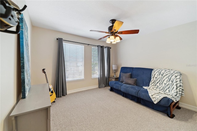 sitting room featuring baseboards, carpet floors, and ceiling fan