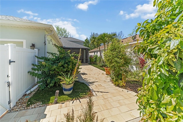 exterior space featuring a patio, fence, and a gate