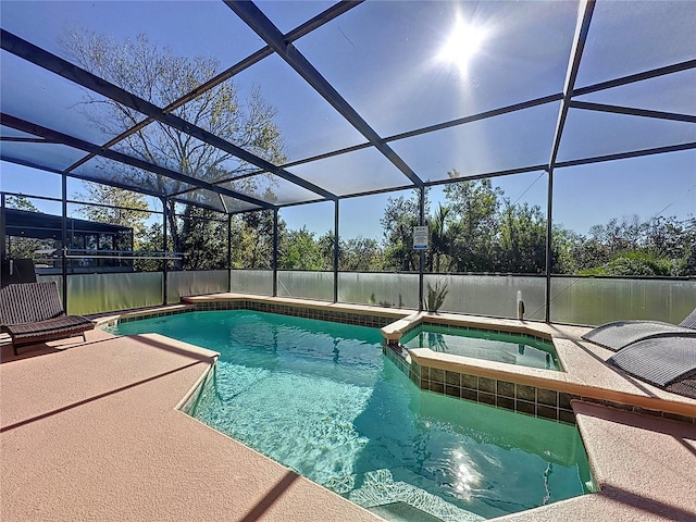 view of pool with a patio, a lanai, and a pool with connected hot tub