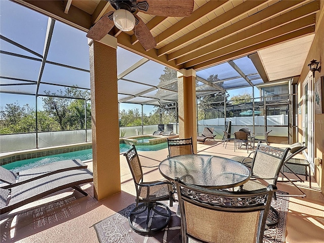 view of patio / terrace with a lanai, a pool with connected hot tub, and a ceiling fan