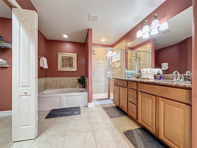 bathroom featuring visible vents, a shower stall, a garden tub, and a sink