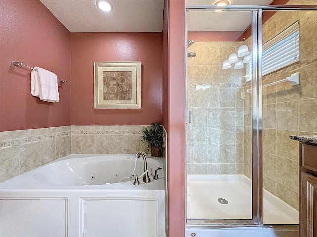 bathroom with a stall shower and a jetted tub