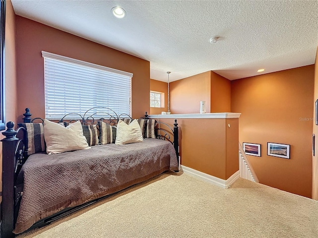 bedroom with recessed lighting, carpet floors, and a textured ceiling