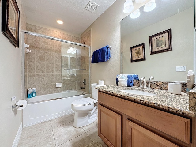 bathroom with vanity, visible vents, a textured ceiling, tile patterned floors, and toilet