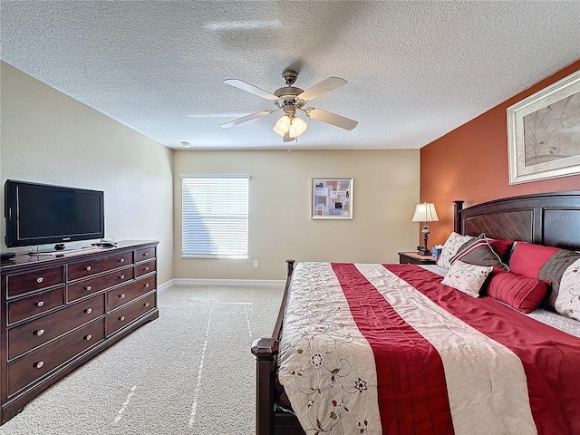 bedroom with baseboards, light colored carpet, ceiling fan, and a textured ceiling