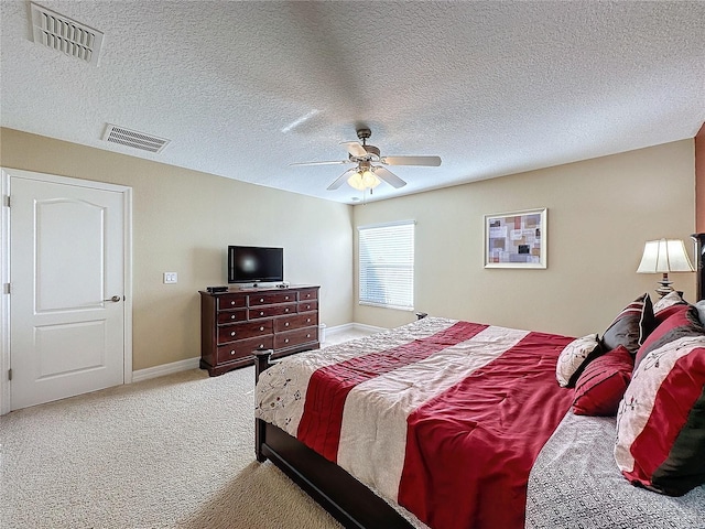 bedroom with visible vents, baseboards, ceiling fan, and carpet floors