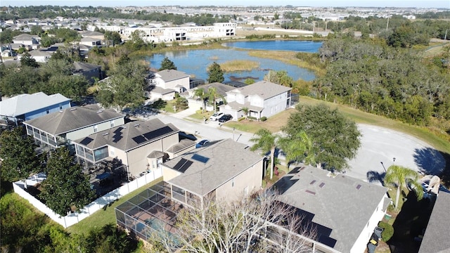 drone / aerial view featuring a residential view and a water view