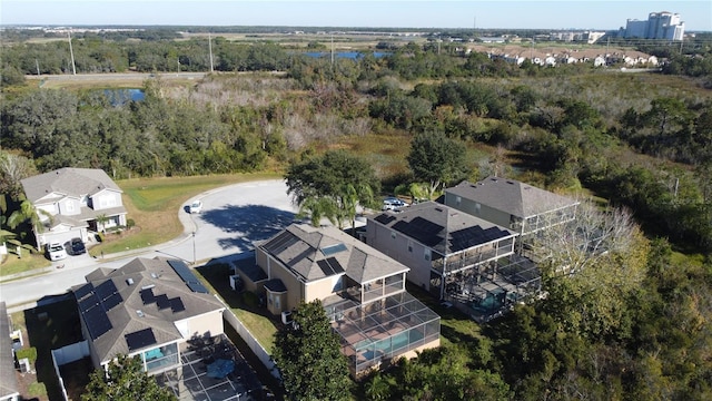 birds eye view of property featuring a residential view, a view of trees, and a water view