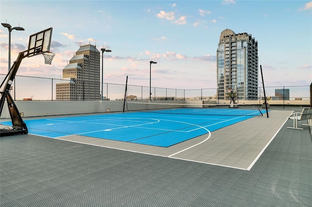 view of sport court featuring a view of city, community basketball court, and fence