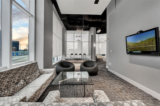 carpeted living area featuring baseboards