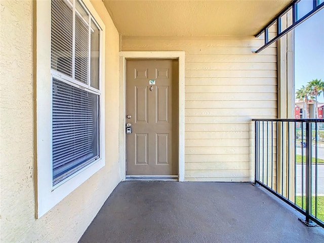 entrance to property featuring stucco siding