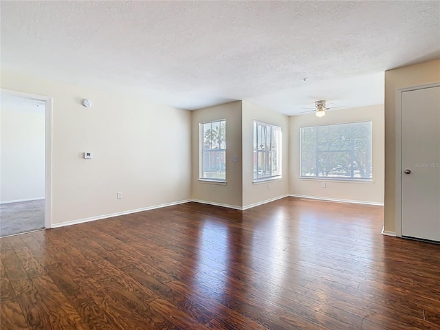 unfurnished room with dark wood-style floors, a textured ceiling, and ceiling fan