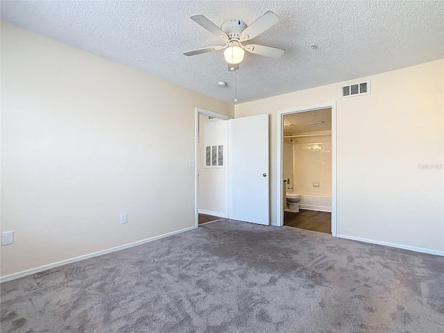 unfurnished bedroom with visible vents, carpet floors, and a textured ceiling