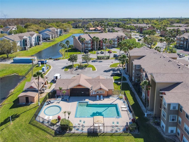 drone / aerial view with a residential view and a water view