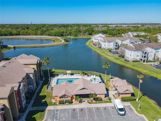 drone / aerial view featuring a residential view and a water view