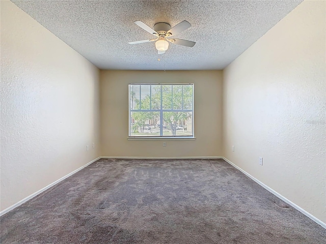 spare room with carpet, a ceiling fan, a textured wall, and a textured ceiling