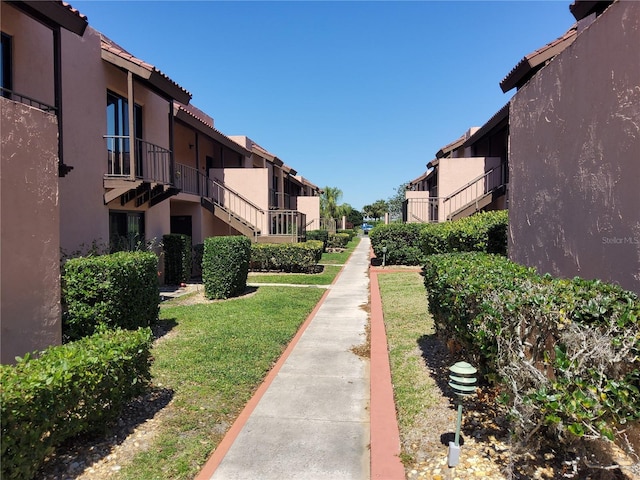 view of home's community with a residential view and a lawn