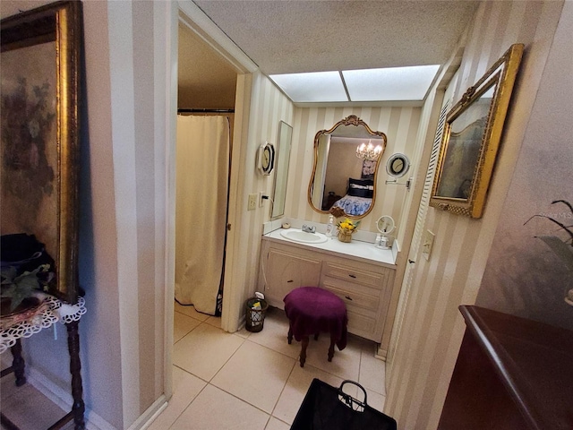 bathroom featuring tile patterned floors, a textured ceiling, and vanity