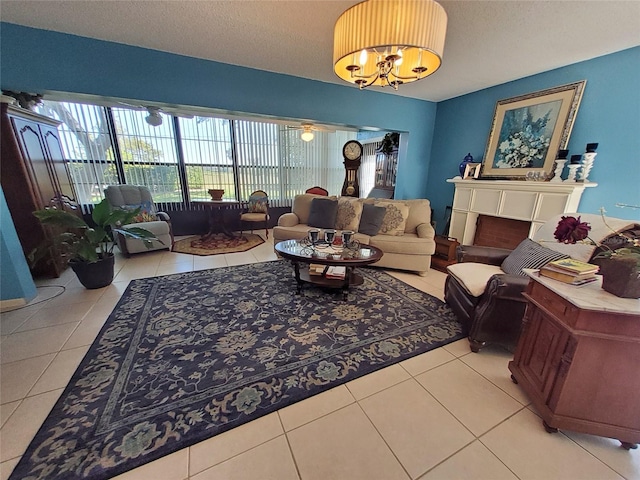 living room with a textured ceiling, a chandelier, and tile patterned flooring