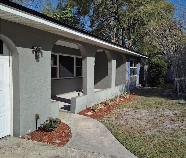 exterior space with a garage and stucco siding