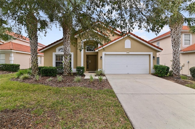 view of front facade with stucco siding, concrete driveway, an attached garage, and a tile roof