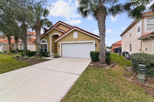 view of front of home featuring stucco siding, a tile roof, concrete driveway, an attached garage, and a front yard