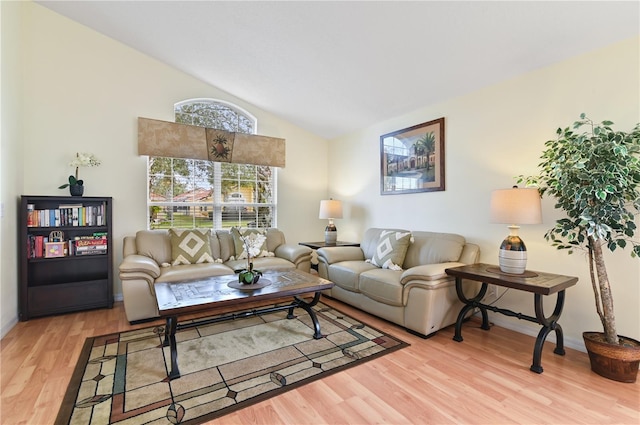 living room featuring vaulted ceiling, wood finished floors, and baseboards