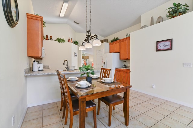 dining space with visible vents, baseboards, vaulted ceiling, light tile patterned flooring, and a textured ceiling