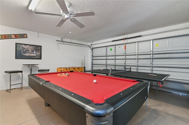 recreation room with billiards, a textured ceiling, concrete floors, concrete block wall, and ceiling fan