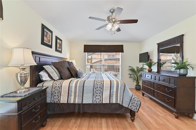 bedroom with light wood finished floors and a ceiling fan