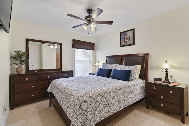 bedroom with ceiling fan and light wood-style flooring