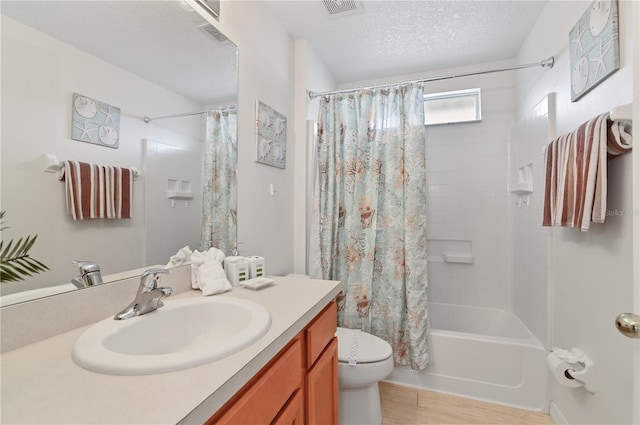 full bath featuring vanity, visible vents, shower / bath combination with curtain, a textured ceiling, and toilet