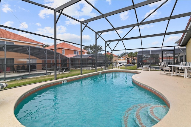 outdoor pool featuring a lanai, a residential view, and a patio