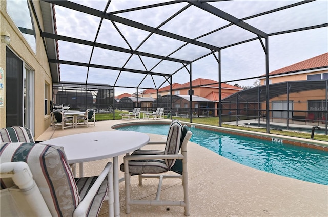 view of swimming pool featuring a patio area, a fenced in pool, and a lanai