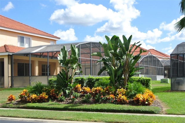 view of yard featuring glass enclosure