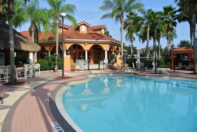 view of pool featuring a patio and fence