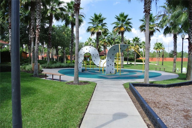 view of home's community featuring a lawn and playground community