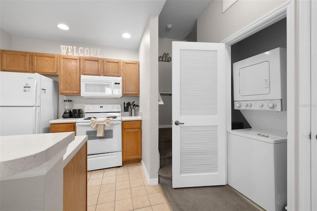 kitchen featuring stacked washer / dryer, light countertops, recessed lighting, light tile patterned flooring, and white appliances