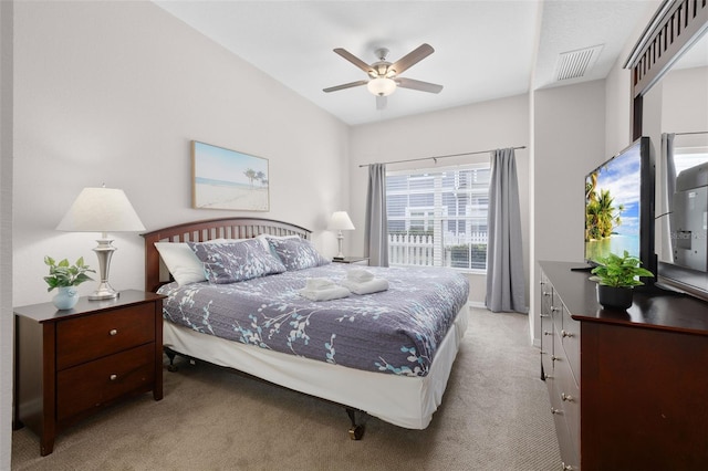 carpeted bedroom with a ceiling fan and visible vents