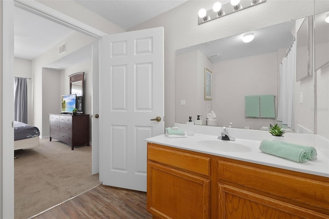 full bath with visible vents, wood finished floors, and vanity