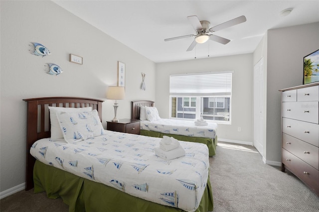 bedroom with baseboards, ceiling fan, and carpet flooring