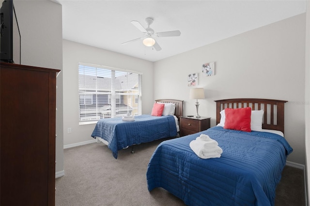 carpeted bedroom featuring baseboards and ceiling fan