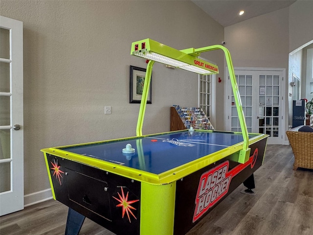 recreation room with baseboards and wood finished floors