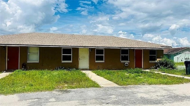 ranch-style house with roof with shingles