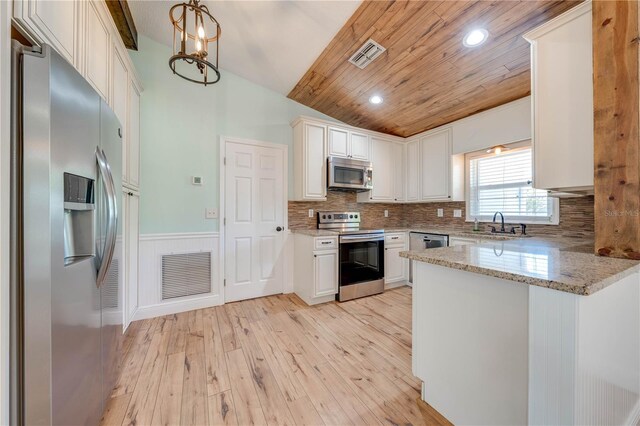 kitchen featuring visible vents, wainscoting, appliances with stainless steel finishes, and light wood-style floors