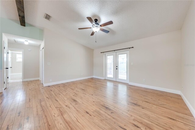 spare room featuring visible vents, french doors, light wood-type flooring, and baseboards