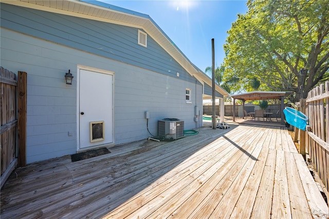 deck featuring central air condition unit, outdoor dining space, and fence