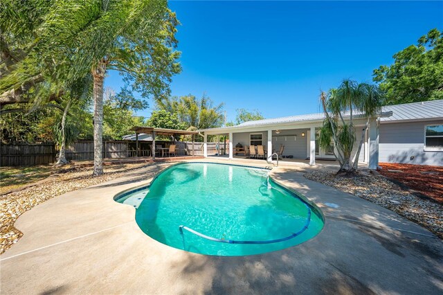 view of swimming pool with a fenced in pool, a fenced backyard, and a patio area